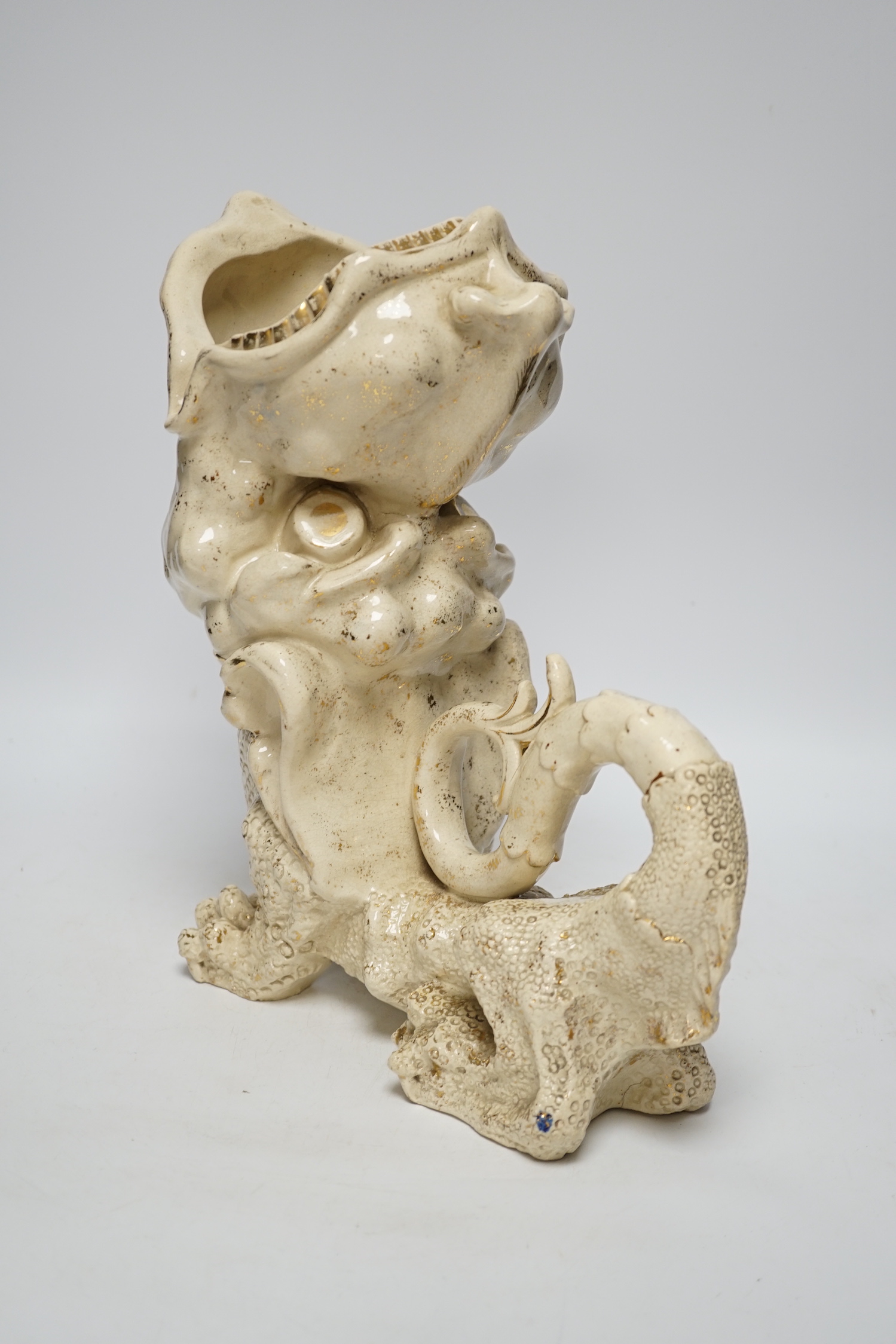 An unusual large cream earthenware gilded vase, early 20th century, modelled as a grotesque pottery mythical beast, 32cm high